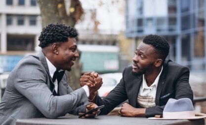 Two african businessman sitting outside cafe _ Free Photo